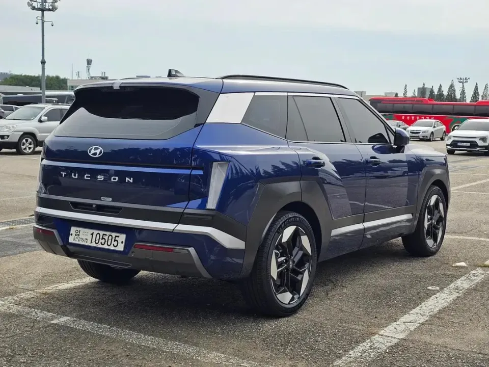 The back of a blue pre-production 2027 Hyundai Tucson with a new rear light design