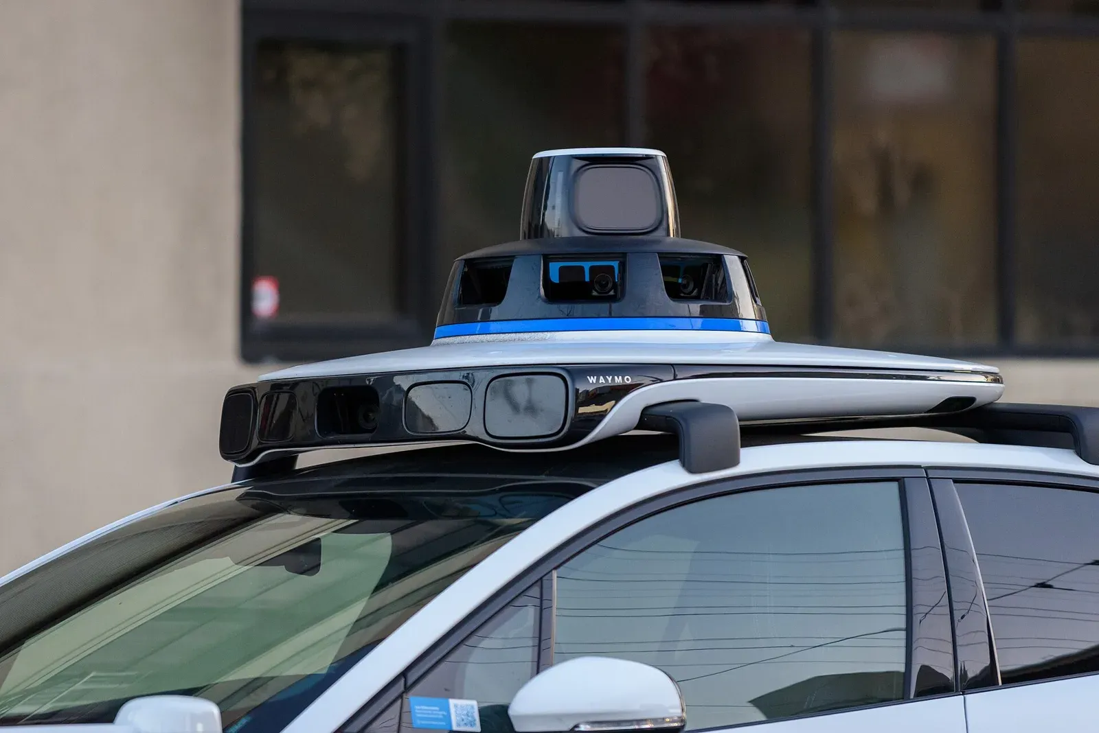Close view of the cameras and lidar sensors on the roof of a Waymo car